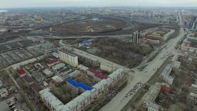 Aerial-survey-on-city.-View-from-the-sky-on-Russian-city.-Aerial-city-view-on-houses,-streets-and-parks.-Grey-sky-and-garages-really-residential-district.-Aerial-survey-on-the-street-where-drive-a-lot-of-car.Chelyabinsk.-Ural.-Overhead-Aerial-Flight-Over