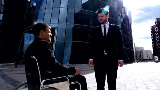 Happy-Entrepreneur-Shaking-Hands-With-Disabled-Businessman-Outdoor