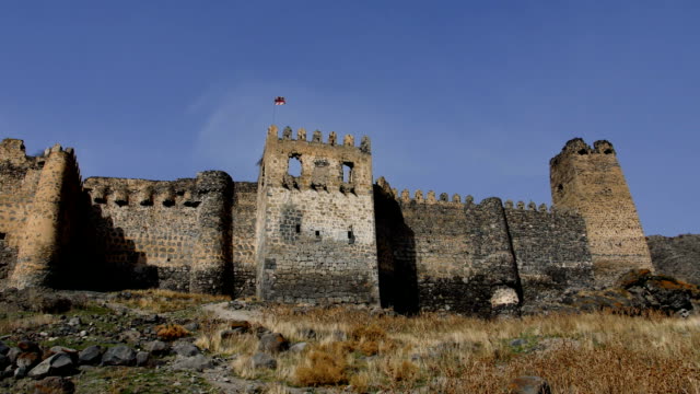 low-angle-view-of-the-bastion,-moat-and-main-outer-wall-at-the-front-of-a-large-ancient-castle