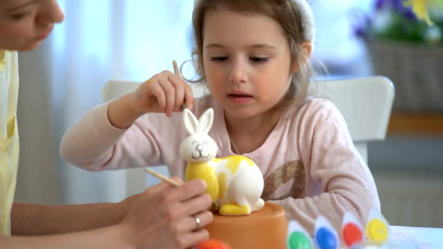 ¡Feliz-Pascua-de-resurrección!-Madre-y-su-hija-pequeña-con-orejas-de-conejo-pintar-conejito-de-Pascua