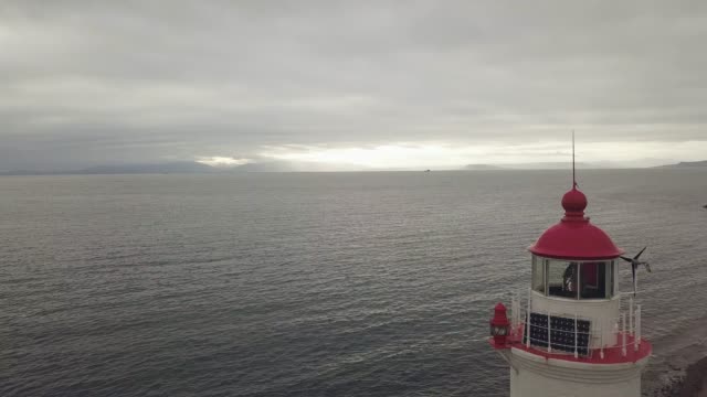 Ansicht-von-oben-Leuchtturm-am-Meer-am-bewölkten-Himmelshintergrund