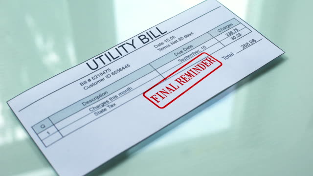 Utility-bill-final-reminder,-hand-stamping-seal-on-document,-payment,-tariff