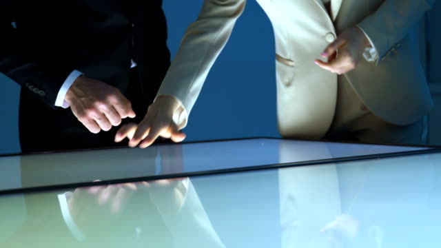 The-businessman-and-a-businesswoman-working-with-a-sensor-screen