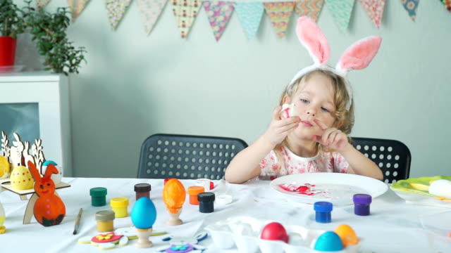 Little-Girl-Eating-Peeled-Easter-Egg-and-Smiling