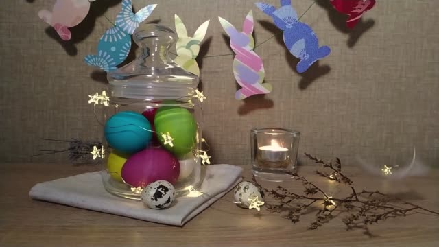 Easter-decoration-burning-candles-falling-feather