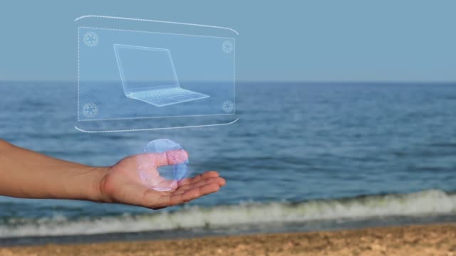 Manos-masculinas-en-la-playa-con-holograma-ultra-Laptop