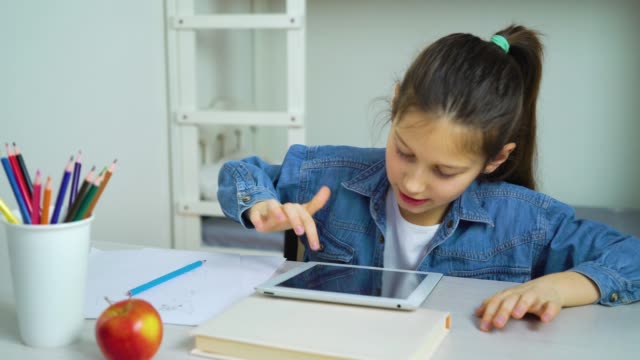 Kleines-Mädchen-berühren-Bildschirm-des-Tablets-beim-Spielen-online