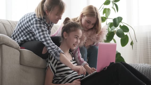 Teenage-girls-browsing-social-media-content-on-laptop