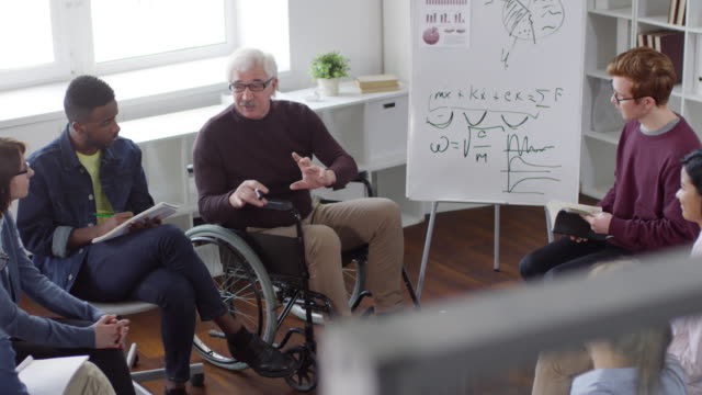 Sequence-of-Disabled-Professor-Talking-to-Students