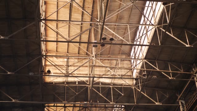 Old-Industrial-Hall-with-Metal-Beams-Under-Ceiling