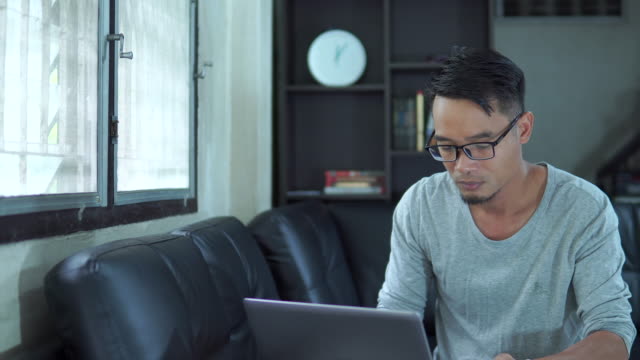 Asia-man-using-laptop-in-the-living-room