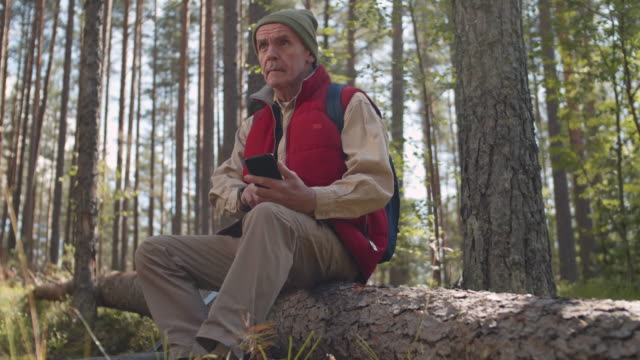 Senior-Using-Modern-Devices-in-Woods