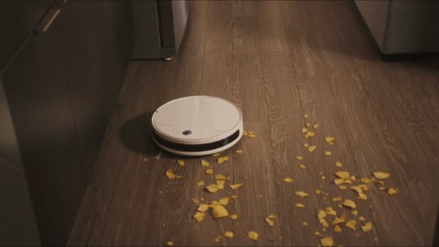 Robotic-vacuum-cleaner-rides-around-apartments-and-cleans-result-of-a-party