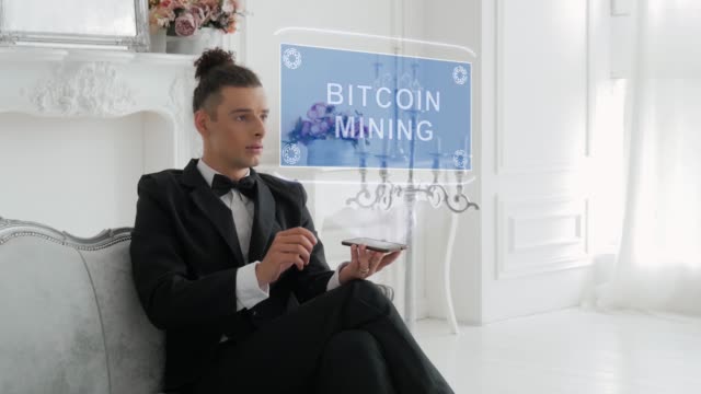 Young-man-uses-hologram-Bitcoin-Mining