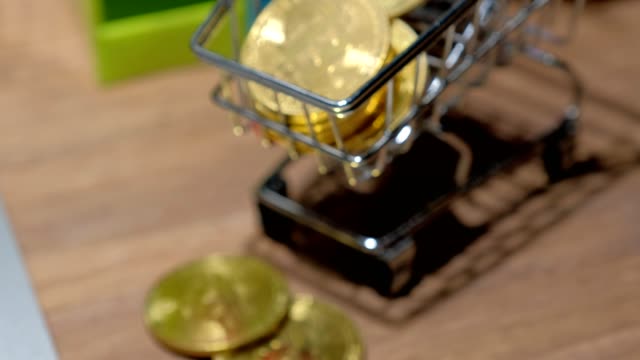 4k-slider-shot-of-Golden-bitcoins-on-business-desk.