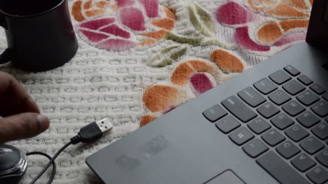Human-hand-connecting-Computer-mouse-connection-cable-plug-in-the-laptop-keyboard.-Network-connection-plugin-internet-of-things-and-modern-wireless-technology-backgrounds.