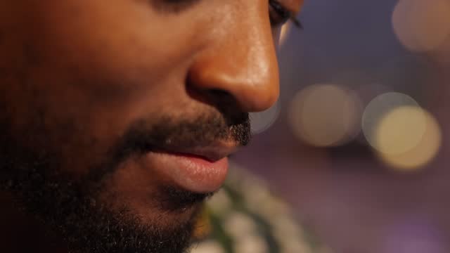 Close-up-African-American-mouth-talks-by-smartphone