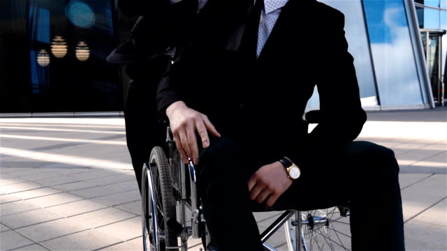 Head-of-business-dismiss-his-handicapped-disabled-employee-sitting-in-wheelchar