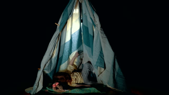 Little-cute-girl-in-teepee-tent-in-bedroom-evening.