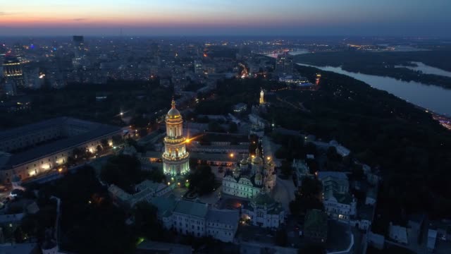 Aerial-view-of-Kiev-Pechersk-Lavra-at-sunset-hour.-Flying-over-Kyiv-Pechersk-Lavra-Orthodox-Monastery-at-night.-Kiev,-UKraine