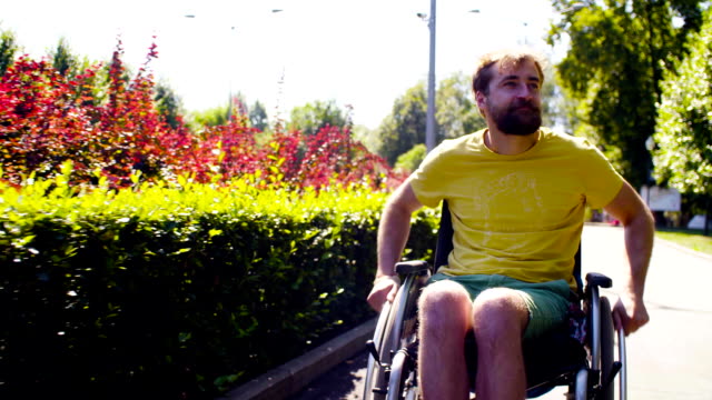 Young-disable-man-in-wheelchair-in-the-park