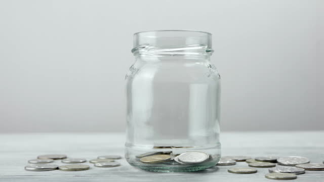 Coins-falling-into-the-jar.-Savings-in-the-jar
