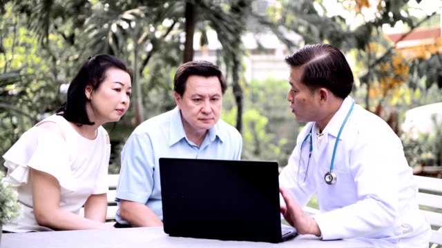 Doctor-and-patient-discussing-medical-examination-outdoor-in-garden.