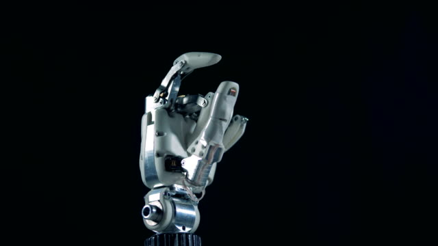 A-robotic-hand-works,-moving-fingers,-close-up.