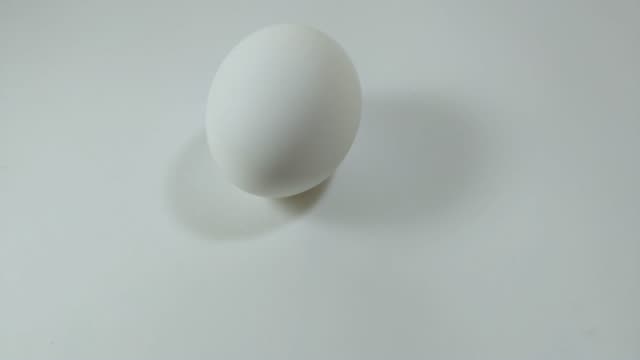 Egg-spinning-and-rolling-on-the-white-table-Easter-egg