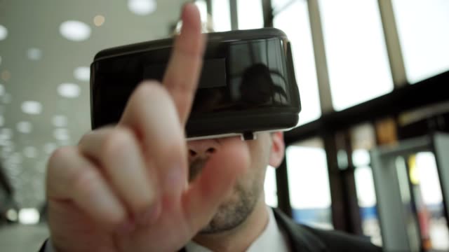 Close-up-shot-of-middle-aged-businessman-in-virtual-reality-headset-working-with-visualized-analytical-data,-tapping-and-swiping-information