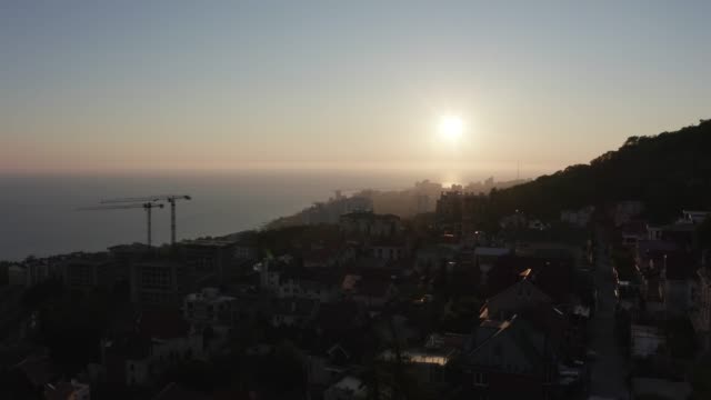 Aerial-video-shooting.-Sunset-over-the-city-of-Sochi.-Evening-light.-City-resort-on-the-black-sea.