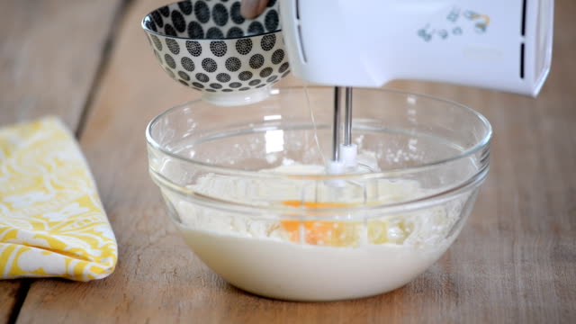 Adding-eggs-to-dough.-Making-cake-in-the-kitchen.