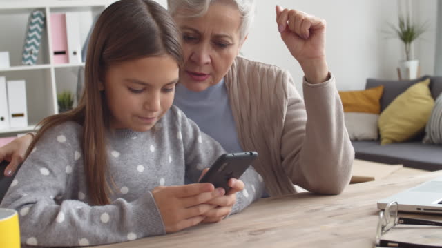 Grandmother-and-Grandchild-Using-Phone