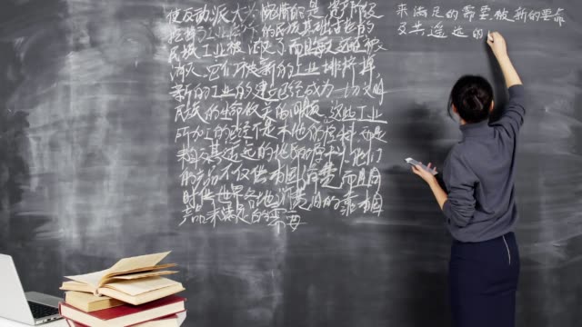 Female-Student-Writing-Hieroglyphs-on-Blackboard