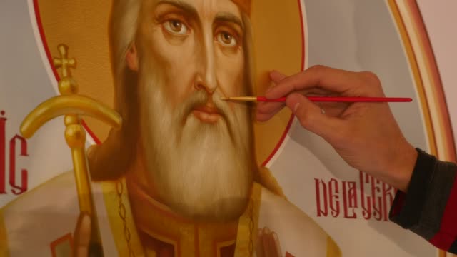 Hand-des-Mannes-Künstler-ist-stehend-und-Symbol-der-orthodoxen-Heiligen,-hält-eine-Palette-mit-Farben-malen
