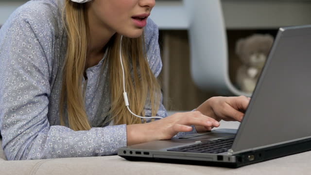 Girl-in-headphones-communicating-in-video-chat,-social-networks,-youth-lifestyle