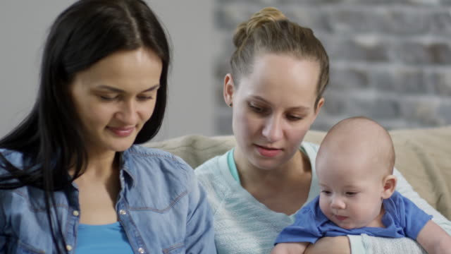 Female-Couple-Spending-Time-with-Baby