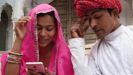 Good-looking-couple-worried-concerned-about-bad-news-from-the-internet-on-smart-cell-mobile-phone-screen