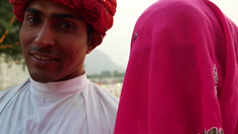 Closeup-handheld-portrait-of-Indian-husband-with-turban-and-shy-wife-in-sari-traditional