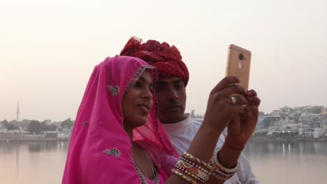 Handheld,-Rajasthani-paar-unter-Selfies-von-einer-Handy-Kamera-auf-der-Pushkar-See,-Indien