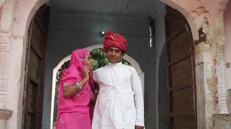 Indische-Paare-stehen-und-posiert-für-die-Kamera-in-ihre-alten-traditionellen-Hauses-in-Rajasthan,-Indien