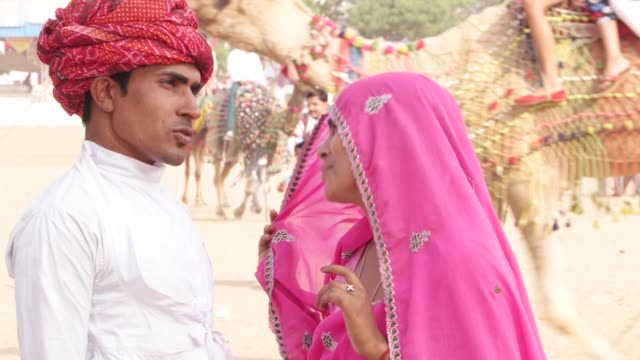 Rajasthani-smart-and-beautiful-couple-at-the-busy-fairgrounds-of-Pushkar-Fair,-India