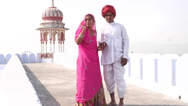 Beautiful-bride-and-groom-dating-leisurely-on-a-rooftop-in-Pushkar,-Rajasthan,-India
