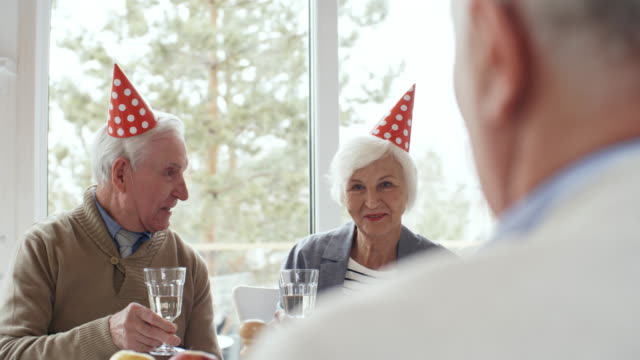 Senior-Couple-Talking-at-Birthday-Party