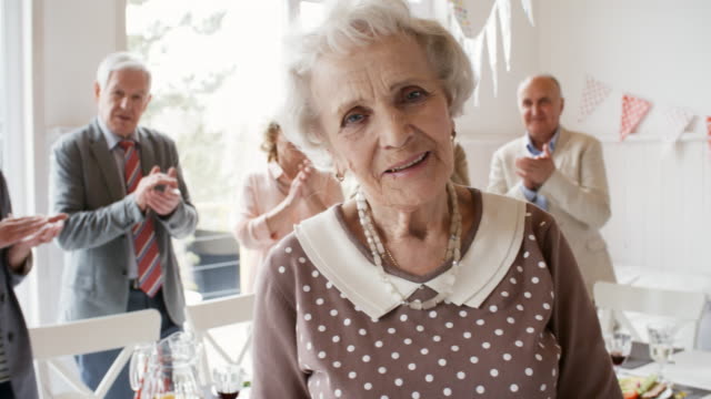 Elderly-Lady-Posing-at-Birthday-Dinner-with-Friends