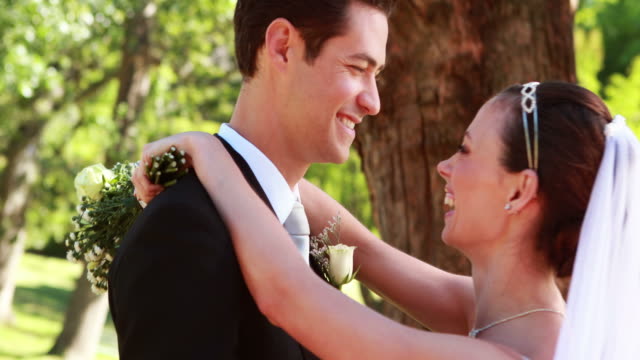Newlyweds-dancing-together-and-smiling-at-camera