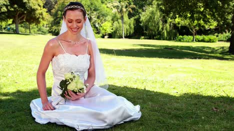 Content-bride-sitting-on-the-grass