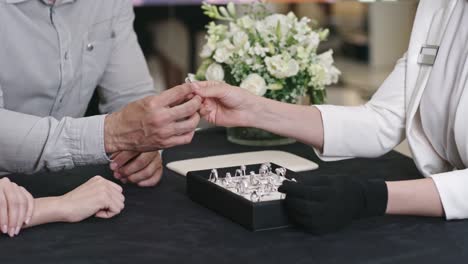 Man-Helping-His-Bride-to-Try-On-Wedding-Ring