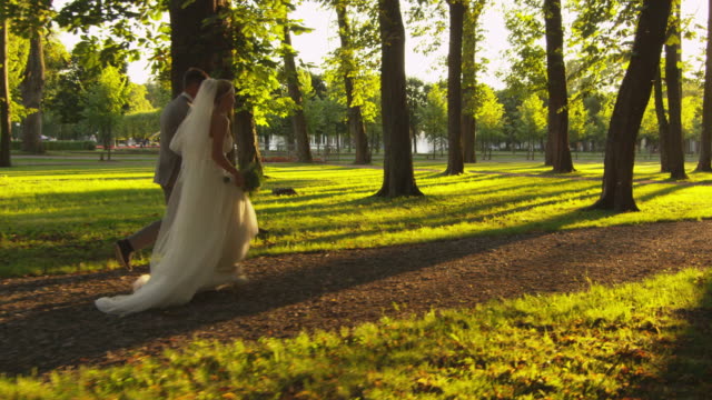 Newlyweds-are-running-in-the-park.