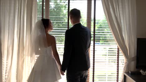 Bride-and-groom-beside-window.